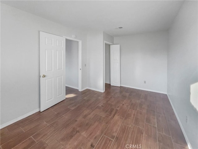 unfurnished room featuring dark hardwood / wood-style flooring