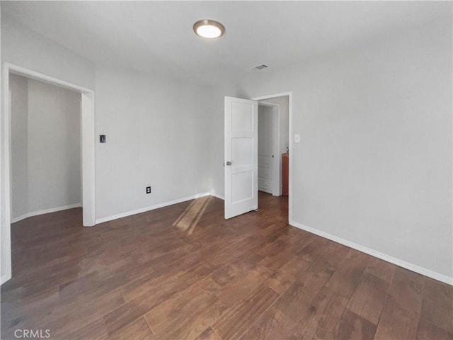 unfurnished bedroom featuring dark hardwood / wood-style floors