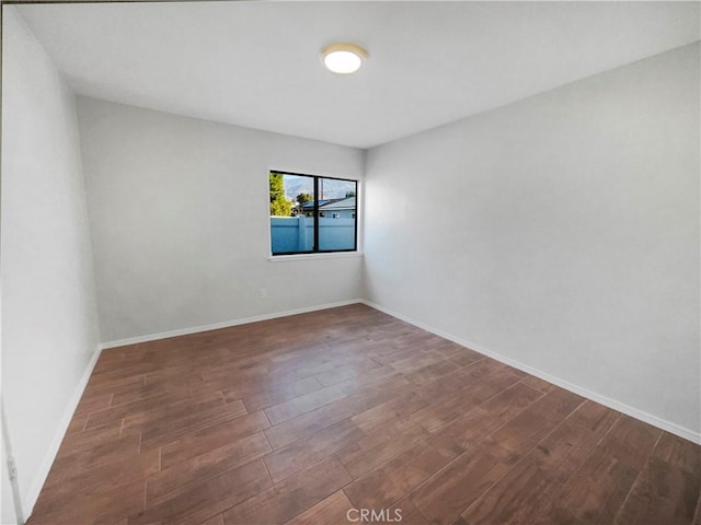 spare room featuring dark wood-type flooring