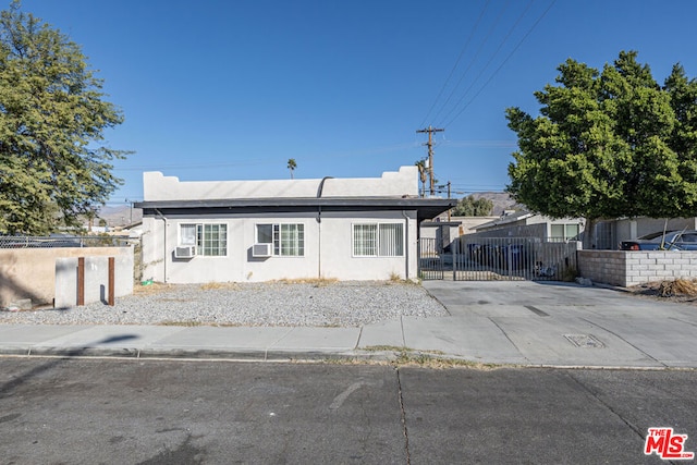 ranch-style home with cooling unit