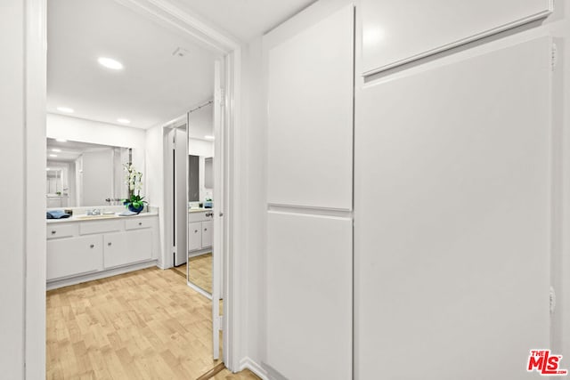 bathroom with hardwood / wood-style floors and vanity