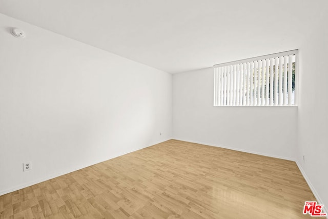 spare room featuring light hardwood / wood-style flooring