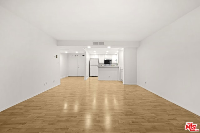 unfurnished living room with light wood-type flooring