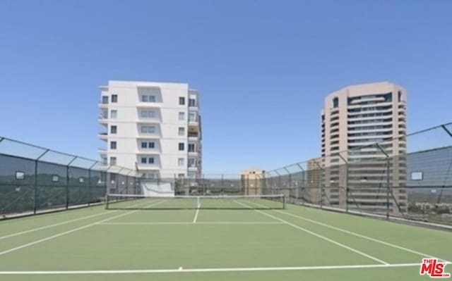 view of tennis court featuring basketball hoop