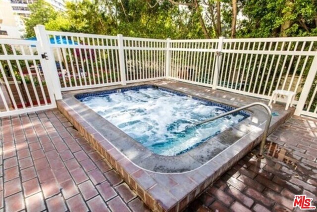 exterior space featuring an in ground hot tub