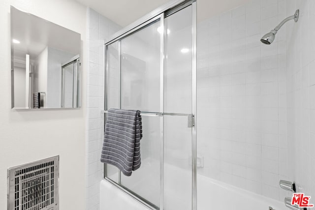 bathroom featuring shower / bath combination with glass door