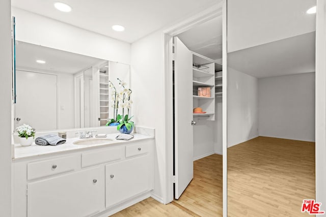 bathroom with hardwood / wood-style flooring and vanity