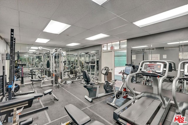 workout area with a paneled ceiling