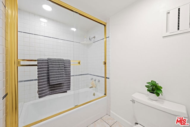 bathroom with toilet, tile patterned floors, and shower / bath combination with glass door