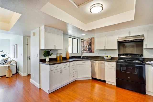 kitchen with white cabinetry, black range with electric cooktop, stainless steel dishwasher, and a raised ceiling