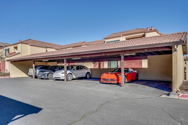 view of parking / parking lot featuring a carport