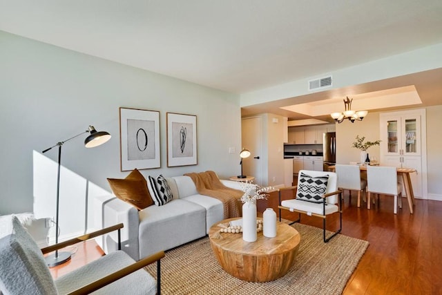 living room with an inviting chandelier and hardwood / wood-style floors