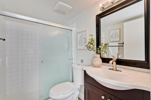 bathroom with vanity, an enclosed shower, and toilet