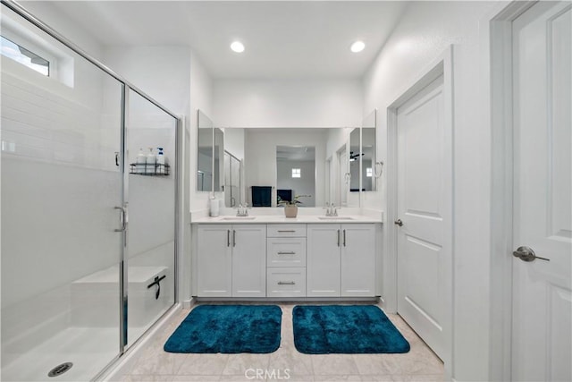 bathroom featuring vanity, tile patterned floors, and a shower with shower door