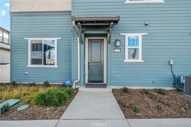 entrance to property featuring central AC unit