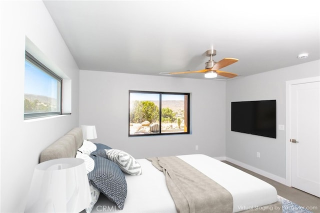 bedroom featuring multiple windows and ceiling fan