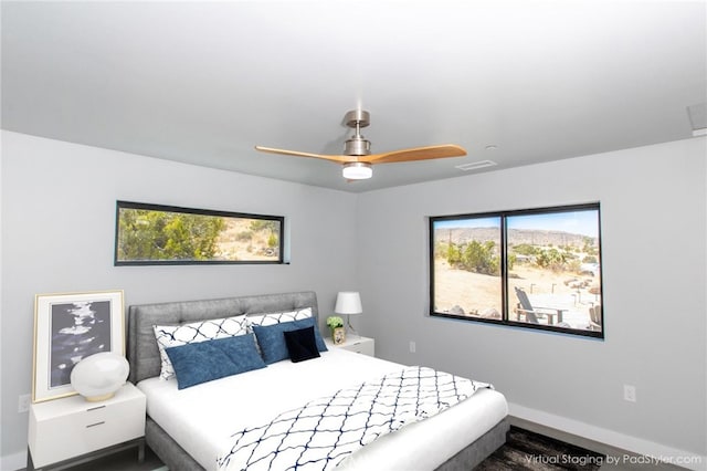 bedroom with ceiling fan and multiple windows