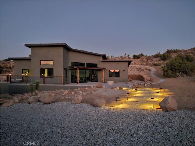 view of back house at dusk