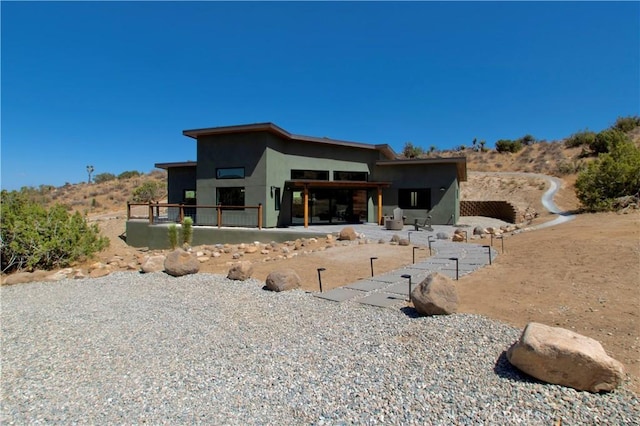 back of house with a patio area and stucco siding