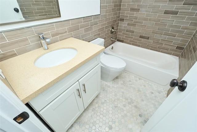 full bathroom featuring toilet, shower / bath combination, backsplash, tile walls, and vanity