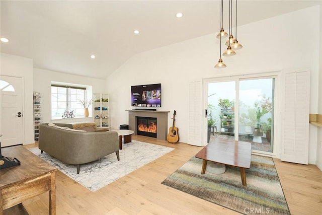 living room featuring vaulted ceiling and light hardwood / wood-style floors