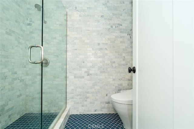 bathroom featuring toilet, tile walls, and an enclosed shower