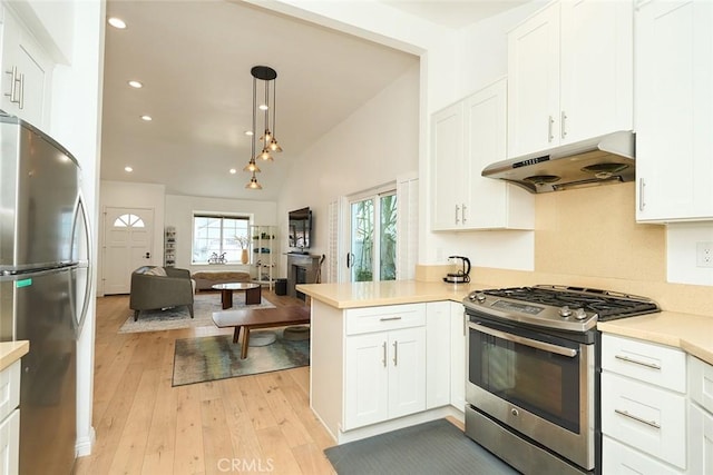 kitchen with decorative light fixtures, white cabinetry, and appliances with stainless steel finishes