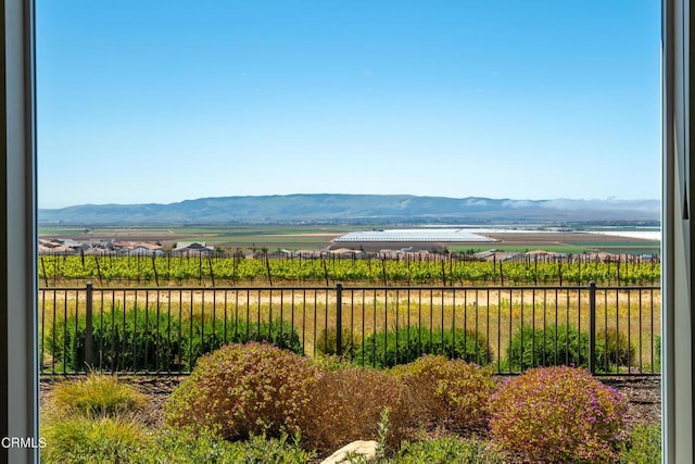 view of mountain feature with a rural view and a water view