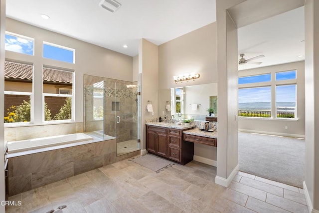 bathroom featuring ceiling fan, separate shower and tub, and vanity