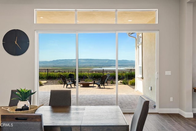 dining area featuring a mountain view and hardwood / wood-style floors