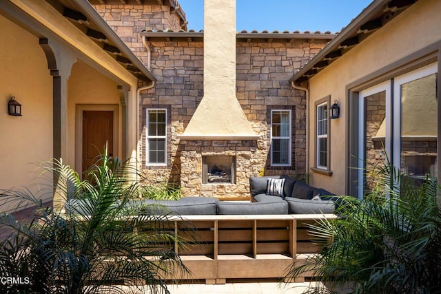 view of patio / terrace with an outdoor living space with a fireplace