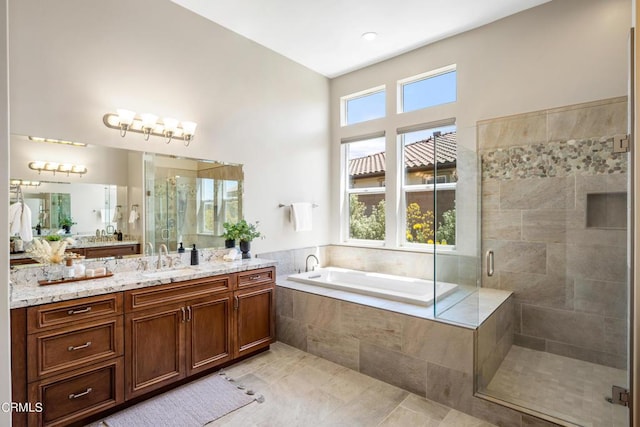 bathroom featuring tile patterned flooring, separate shower and tub, and vanity