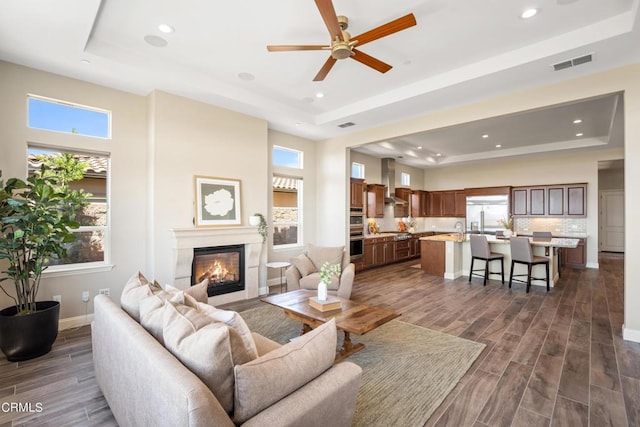 living room featuring a wealth of natural light and a tray ceiling