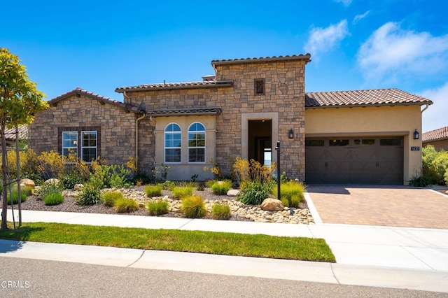 mediterranean / spanish-style home with a garage