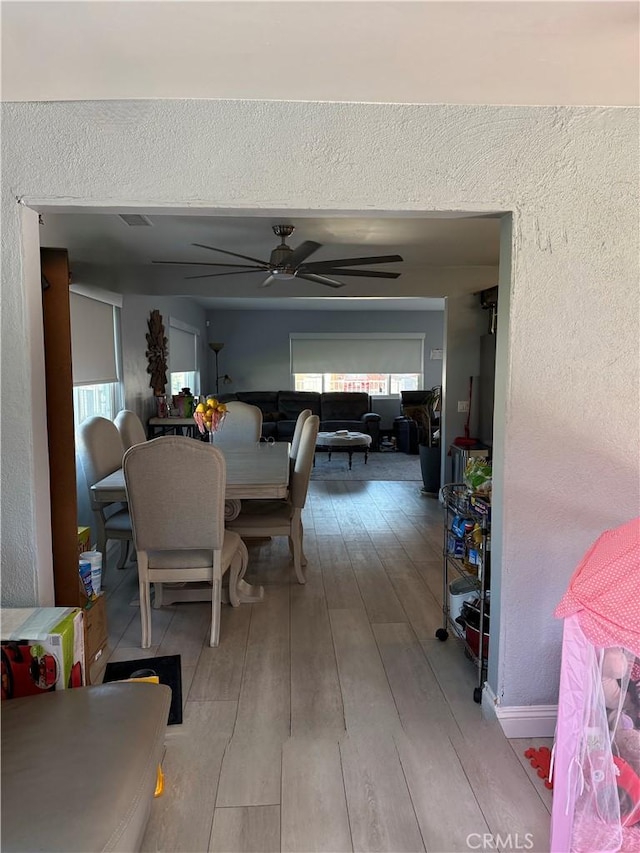 dining room featuring ceiling fan and light wood-type flooring