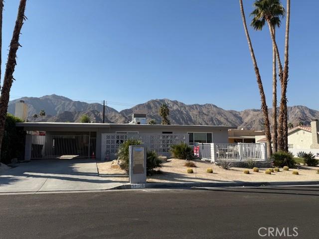 view of front facade featuring a carport and a mountain view