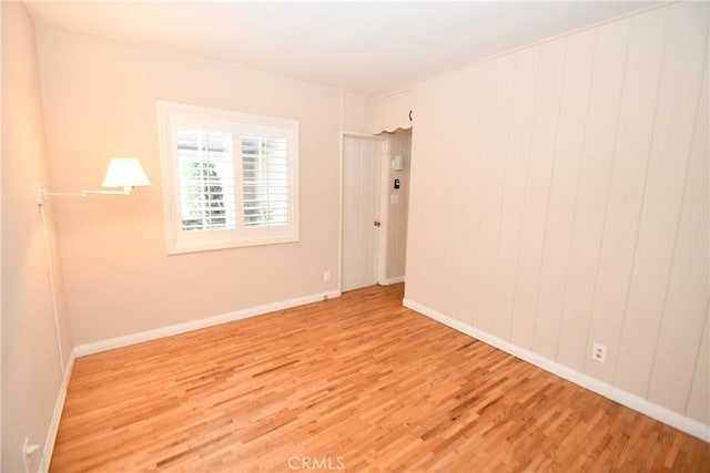 unfurnished room featuring hardwood / wood-style flooring