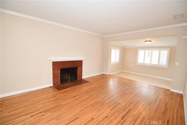 unfurnished living room with a brick fireplace, ornamental molding, and light wood-type flooring