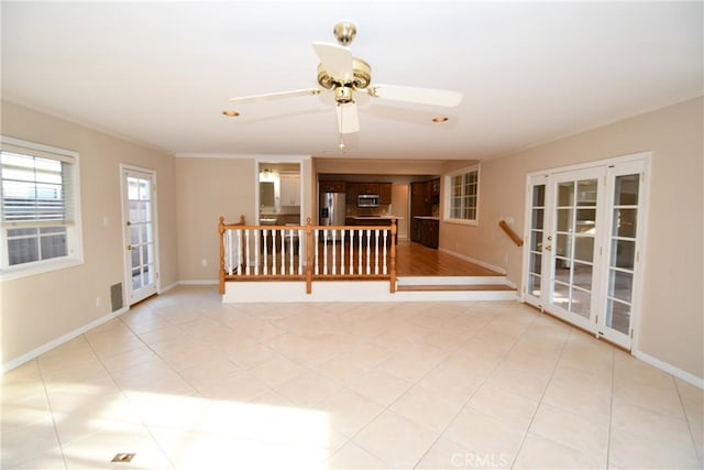 unfurnished room with light tile patterned flooring, ceiling fan, ornamental molding, and french doors