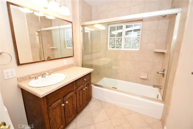 bathroom with combined bath / shower with glass door, vanity, and tile patterned flooring