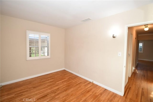 empty room with hardwood / wood-style flooring