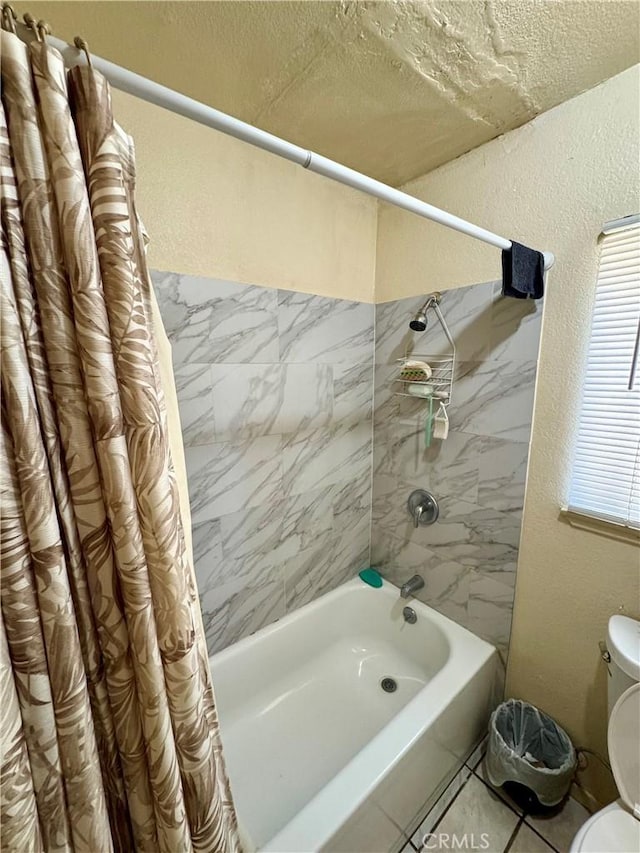 bathroom featuring a textured ceiling, toilet, shower / tub combo, and tile patterned flooring