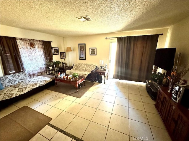 tiled living room featuring a textured ceiling