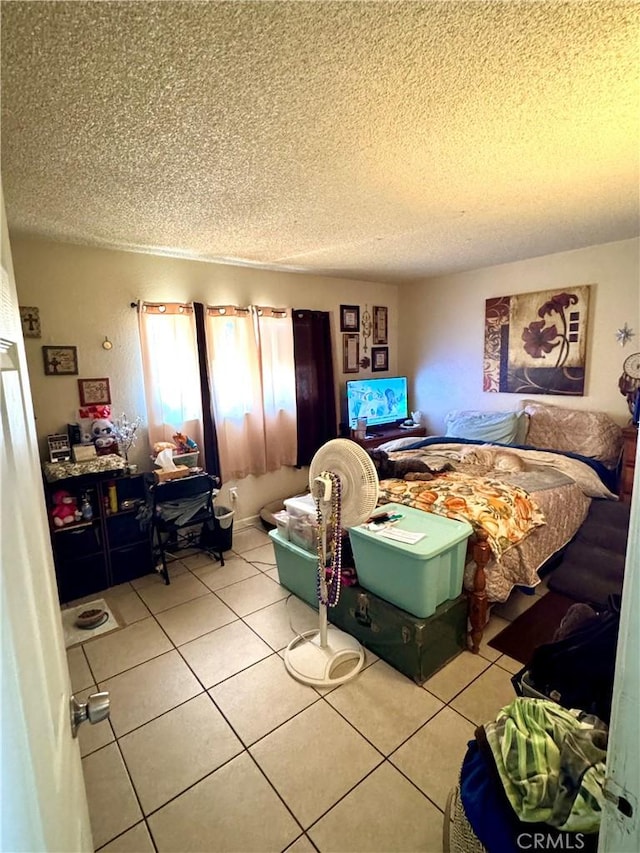 tiled bedroom with a textured ceiling