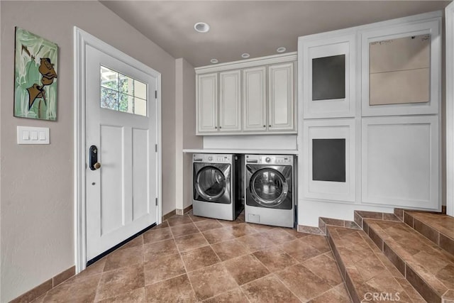 washroom featuring cabinets and washing machine and dryer