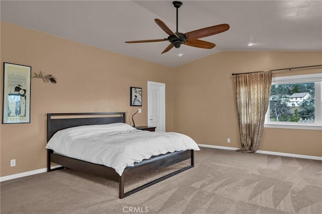 carpeted bedroom with ceiling fan and vaulted ceiling