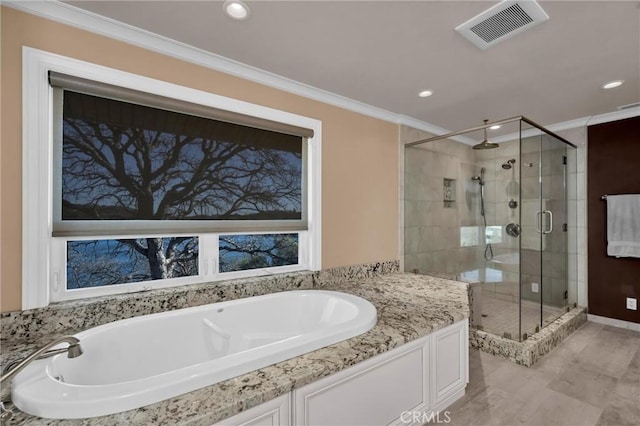 bathroom with crown molding and independent shower and bath