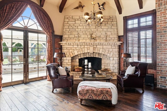 living area with hardwood / wood-style flooring, a notable chandelier, a fireplace, high vaulted ceiling, and beamed ceiling