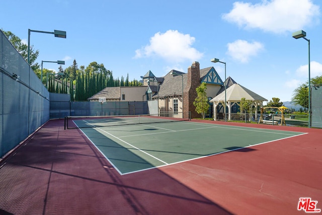 view of tennis court featuring basketball court