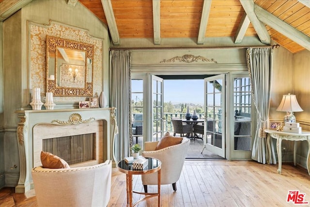 living area with wooden ceiling, vaulted ceiling with beams, a fireplace, and hardwood / wood-style flooring